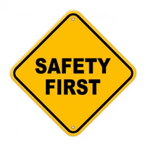 Yellow safety first road sign with rivets